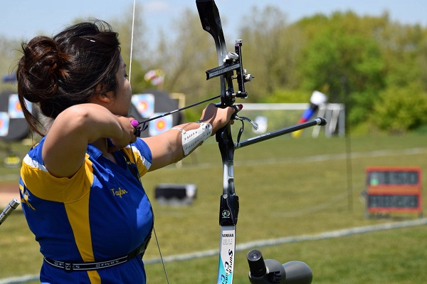 A Young Girl Playing Archery - Significance Of Sports Concept. 